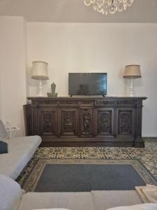 a wooden entertainment center in a living room with a television at Villa Margherita in Terrasini