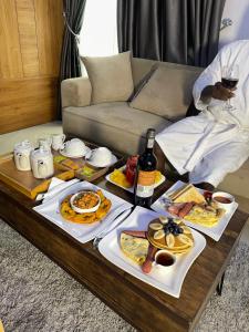 a table full of food and wine on a couch at Morgan Hill Residence in Abuja