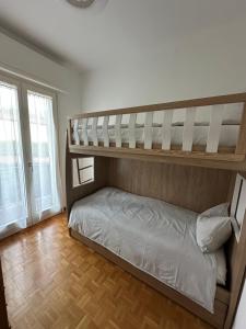 a bedroom with two bunk beds and a wooden floor at Casa Gioia in Besano