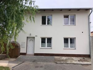 a white house with a white door at Jako doma in Ivaň