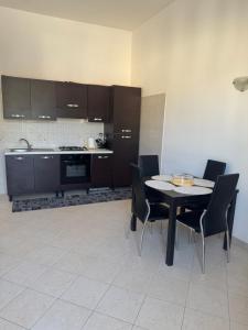 a kitchen with a table and chairs in a room at La Bella Vista 9 - Fondi in Fondi
