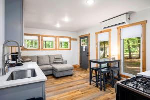 a kitchen and living room with a couch and a table at Arbutus Lake-King Suite-Pontoon Rentals in Traverse City