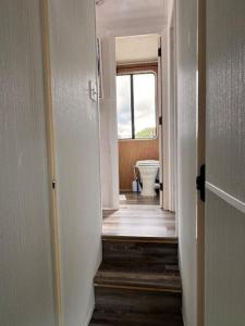 a hallway leading to a bathroom with a toilet at b3 Couples Therapy Yacht in La Crosse +12 photos