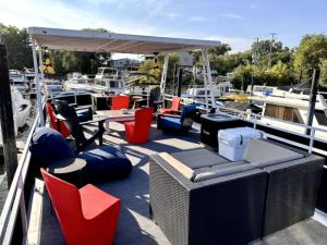 a dock with chairs and tables and chairs on a boat at b3 Couples Therapy Yacht in La Crosse