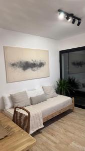 a living room with a couch and a table at Departamento en Rojas in Rojas