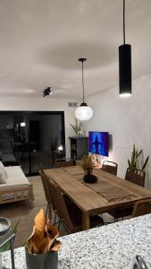 a living room with a table and a living room with a couch at Departamento en Rojas in Rojas
