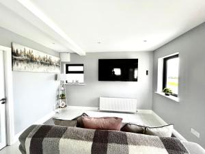 a living room with a couch and a table at The Ocean Nest in Loughaunbeg