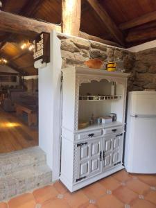 a kitchen with a white cabinet and a refrigerator at New Riyork Sweet Home in Geres