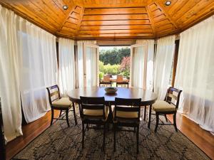 a dining room with a wooden table and chairs at Quinta de Valverde in Viana do Castelo