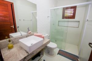a bathroom with a sink and a shower and a toilet at Casa_Mare11 in São Miguel do Gostoso +44 photos