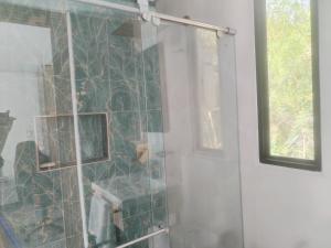 a shower with a glass door next to a window at Villas Entre Lagos in Lebrija +56 photos