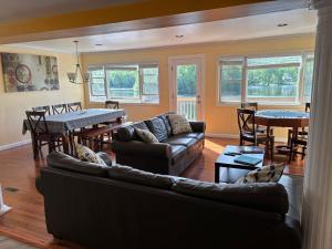 a living room with a couch and a table at Large family house on the lake in Hewitt +30 photos