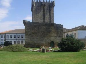 an old building with a tower in the middle of a field at Bem estar 3 in Chaves