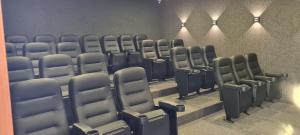 an empty auditorium with blue chairs in a room at Vista Linda Eco Resort Carneiros in Tamandaré +134 photos