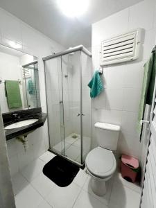 a bathroom with a toilet and a glass shower at Apartamento BELÉM COP 30 in Belém