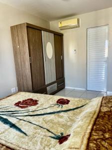 a bedroom with a bed with red flowers on it at Apartamento BELÉM COP 30 in Belém +20 photos