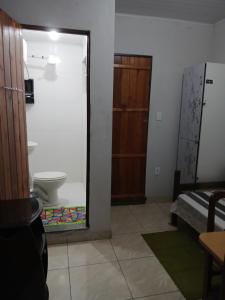 a room with a bathroom with a toilet and a mirror at Pousada Familiar 31 in Campos dos Goytacazes +13 photos