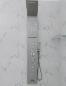 a shower with a strainer and a toothbrush at Mangroven River View Hotel in Bentota