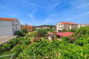 a view from the roof of a house with a garden at Apartments Milorad M in Lopar