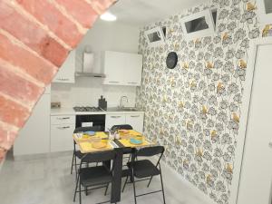 a kitchen with a table and chairs in a room at Tuscany central home in Figline Valdarno