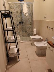a bathroom with a shower and a toilet and a ladder at SaggioHome Holiday House in Naples
