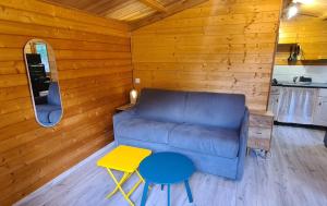 a living room with a couch and a table at Charmant chalet en bois - Ardèche in Joyeuse