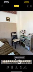 a room with a bedroom with a chair and a desk at Altos del Norte - Salta la Linda ! in Salta