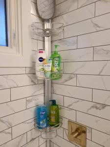 a bathroom rack with soap and cleaning products on it at Spacious 3-Bedroom Home. in Regina +32 photos
