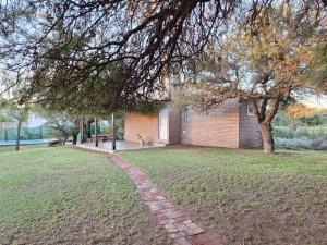 a brick path in front of a house at El Refugio del Calden in Toay
