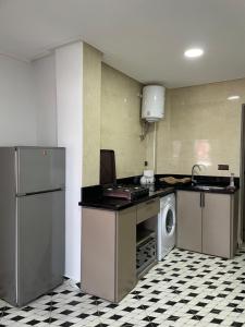 a kitchen with a refrigerator and a washing machine at Appartement de vacance Aourir in Aourir