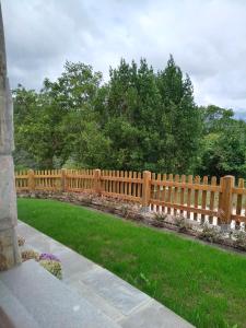 a wooden fence in a yard with green grass at Casamor in Tollo +131 photos