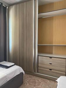 a bedroom with a bed and a closet at Ledi’s Home in Borsh