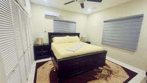 a small bedroom with a bed and a window at Modern Island Escape -Pool-Gym & Patio in Ocho Rios