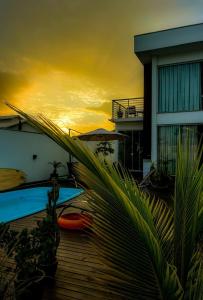 a view of a sunset from the deck of a house at MarisC&LHouse 1- Quarto casal in Bombinhas