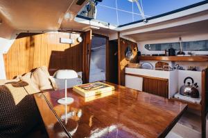 a living room with a wooden table in a boat at Seaside Retreat with Postcard Views in Cascais