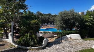 a view of a resort with a pool and trees at Alto Club, Alvor, Portugal in Alvor