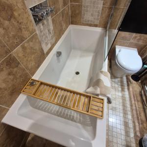 a bath tub with a toilet in a bathroom at Central Brighton, 2 bedrooms, sleeps 5 in Brighton & Hove +7 photos