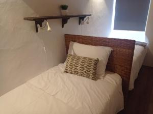 a small bed with a pillow on top of it at Casa da Orada in Avis