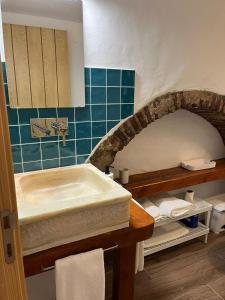 a bathroom with a sink and a counter with towels at Casa da Orada in Avis