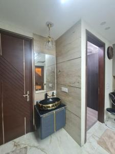 a bathroom with a sink and a mirror at FIAA Hospitality 3BHK 2 FLATS in New Delhi