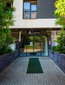 an entrance to a building with a lawn in front of it at Elite Studio Militari Residence in Chiajna