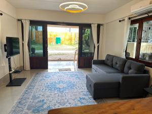 a living room with a couch and a tv at Chaloklumbay resort2 in Mae Haad