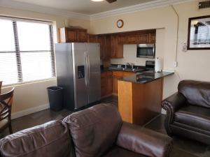 a kitchen with a stainless steel refrigerator and a couch at One Bedroom Downtown in Jacksonville