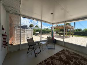 a room with two chairs and a table and a large window at Charming 3-bedroom House In Delightful Englewood in Englewood
