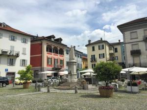 a group of buildings with a statue in a courtyard at 1-bedroom holiday apartment in Locarno