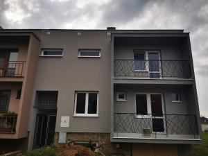 a gray building with windows and a balcony at Vinobike Morava Gold Residence in Moravská Nová Ves