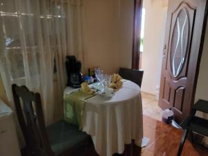 a table with a white table cloth on top of it at Sunflower Place in Portmore