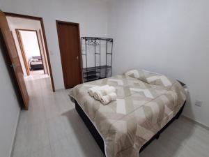 a bedroom with a bed with towels on it at Casa Novinha na Praia in Cabo Frio