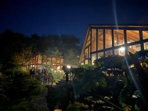 un grupo de personas de pie fuera de un edificio por la noche en Casa Bote, en Puerto Varas 34 fotos más