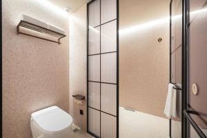 a bathroom with a toilet and a shower at Orange Hotel Beijing Fangshan Changyang Subway Station in Beijing +4 photos